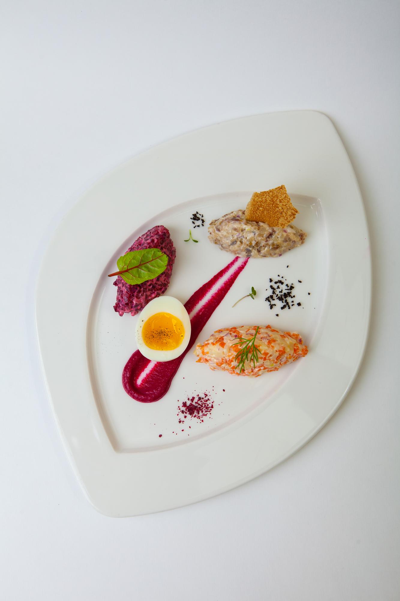 Three plated course examples on tiled table